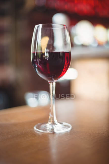 Close-up of glass with red wine on table at bar — Stock Photo