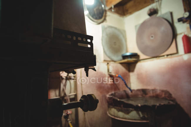 Postazione di lavoro vuota e macchine per la lucidatura del vetro presso la fabbrica di soffiaggio del vetro — Foto stock