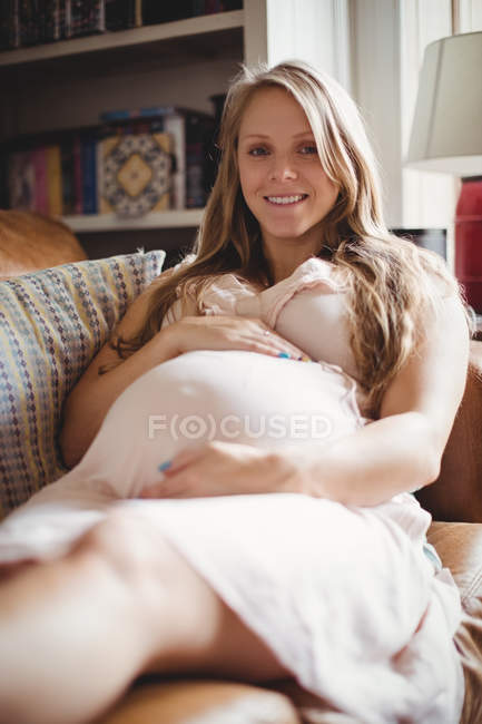 Selective focus of pregnant woman relaxing in living room at home — Stock Photo