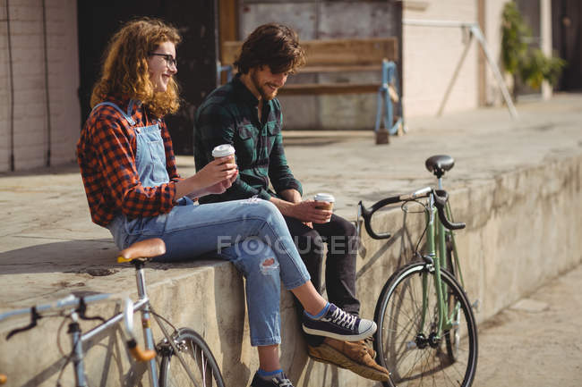 Couple interacting while having a coffee on a sunny day — Stock Photo