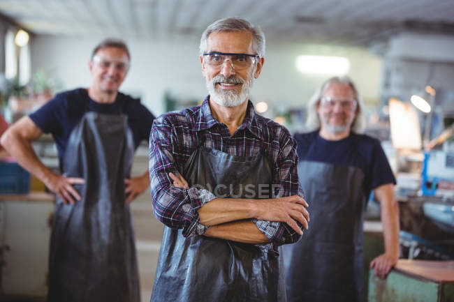 Portrait of mature male glassblowers at glassblowing factory — Stock Photo