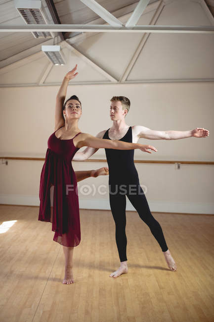 Ballet dancers dancing together in modern studio — Stock Photo