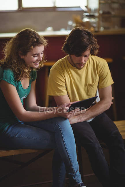 Couple using digital tablet in workshop — Stock Photo