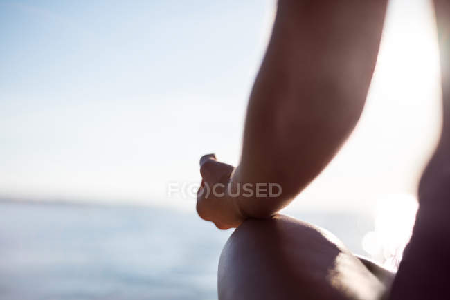 Cropped image of Woman sitting in lotus position with hand showing mudra gesture — Stock Photo