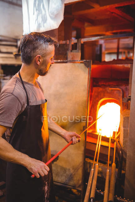 Verre chauffant de souffleur de verre dans le four à l'usine de soufflage de verre — Photo de stock