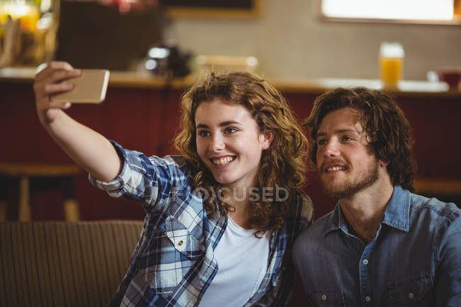 Happy couple taking selfie in workshop — Stock Photo