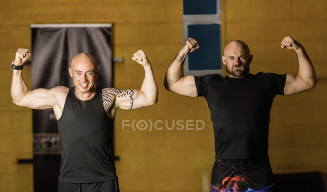 Portrait thai boxers showing muscles in fitness studio — Stock Photo