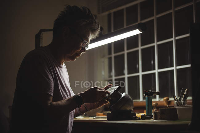 Attentive craftswoman working in workshop — Stock Photo