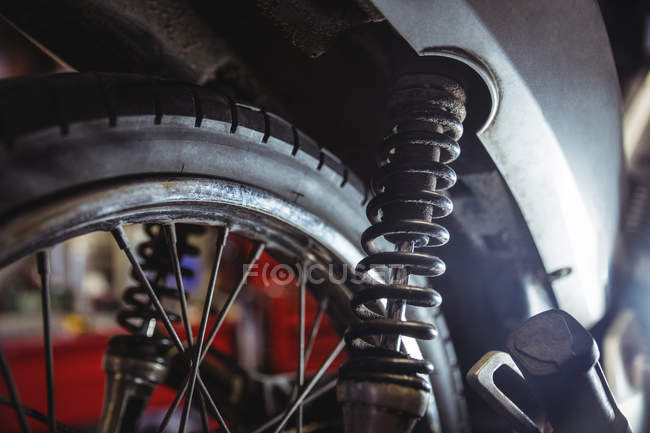Close-up of motorbike shock absorber in workshop — Stock Photo