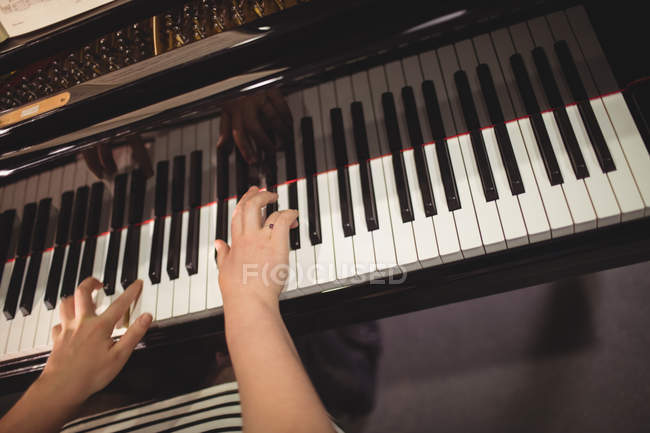 Hands of female student playing piano in a studio — Stock Photo