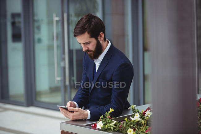 Geschäftsmann benutzt Handy außerhalb des Büros — Stockfoto