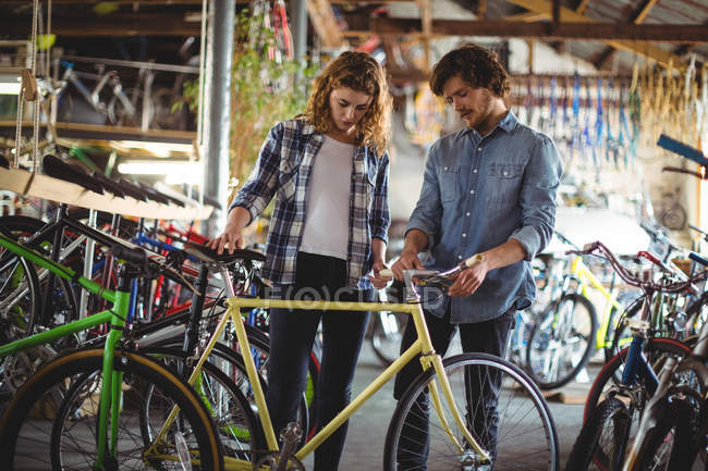 Механика осмотра велосипеда в мастерской — стоковое фото