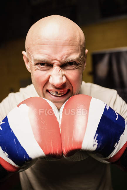 Close up of angry Boxer practicing boxing in fitness studio — Stock Photo