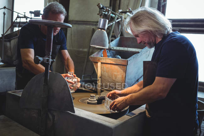 Souffleurs de verre travaillant sur un verre à l'usine de soufflage de verre — Photo de stock