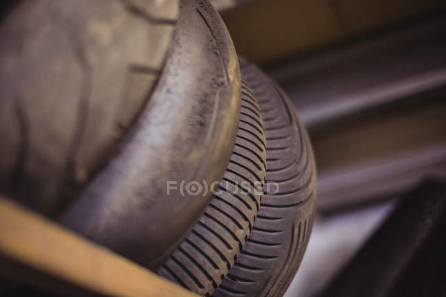 Close-up of motorbike tyres arranged in workshop — Stock Photo