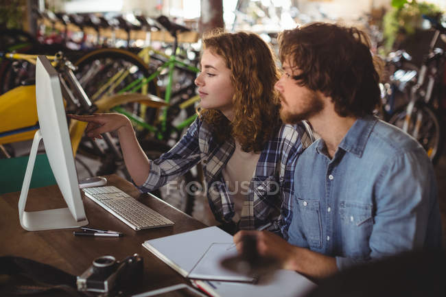Mechanics working on personal computer in workshop — Stock Photo