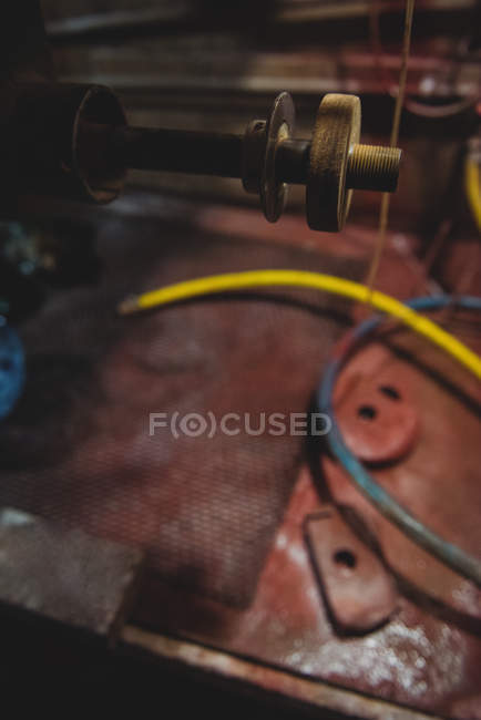 Close-up of empty workstation and glass polishing machinery at glassblowing factory — Stock Photo