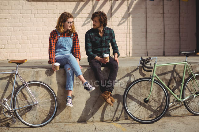 Couple interacting while having a coffee on a sunny day — Stock Photo