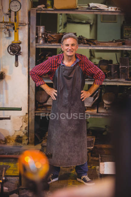 Portrait of glassblower with hands on hips at glassblowing factory — Stock Photo