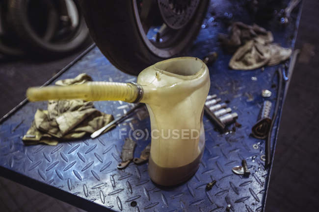 Primer plano de galón de aceite en taller mecánico industrial - foto de stock