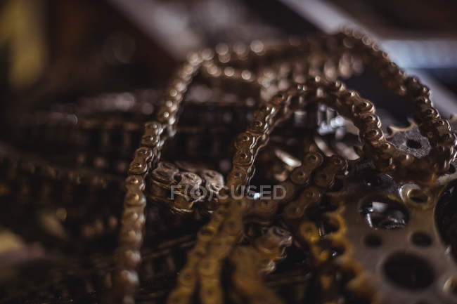 Close-up of motorcycle chains at industrial mechanical workshop — Stock Photo