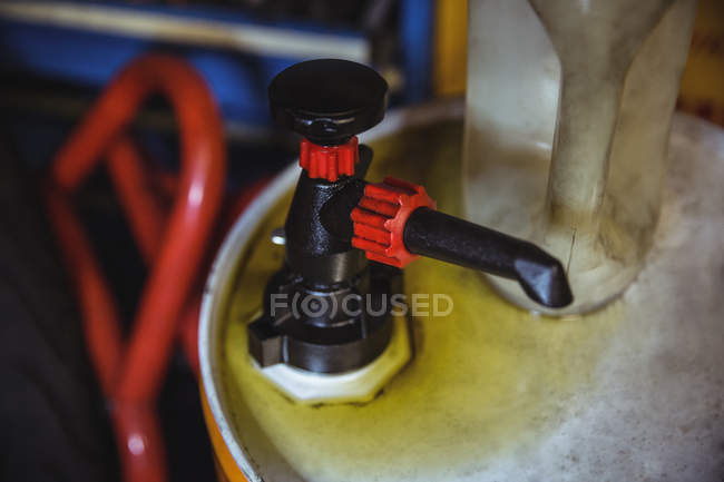Close-up of valve of oil gallon in industrial workshop — Stock Photo