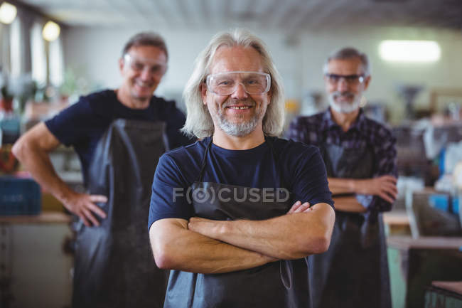 Portrait of glassblowers with arms crossed at glassblowing factory — Stock Photo