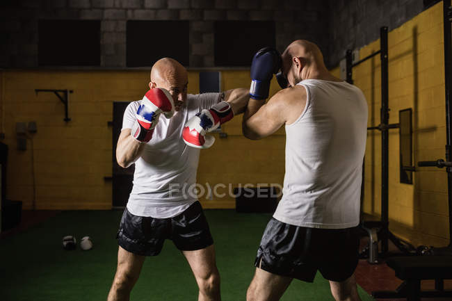 Two thai boxers practicing boxing in gym — Stock Photo