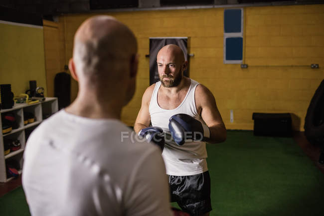 Selective focus of two thai boxers practicing boxing in gym — Stock Photo