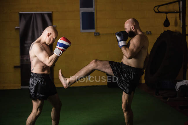 Side view of two thai boxers practicing in gym — Stock Photo