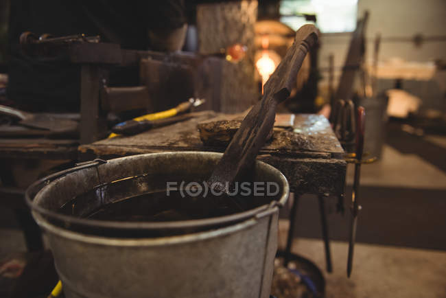 Close-up of glassblowing block in bucket at glassblowing factory — Stock Photo