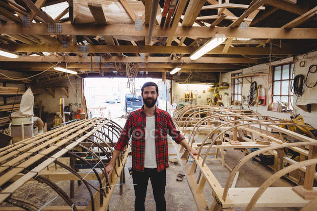 Portrait of smiling man standing in boatyard — Stock Photo