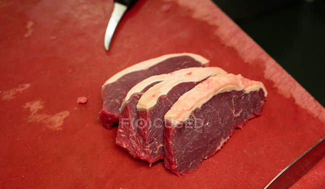 Close-up of chopped meat slices kept on counter — Stock Photo