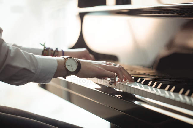 Woman playing a piano in music studio — Stock Photo