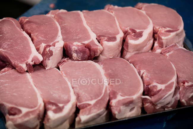 Close-up of raw steaks at butchers shop — Stock Photo