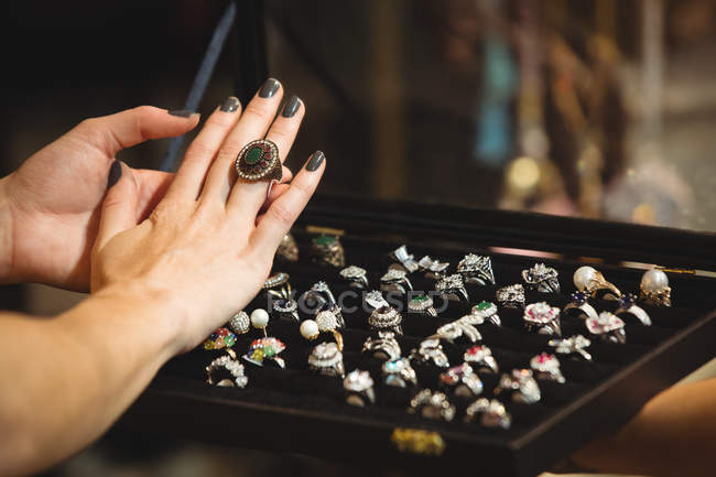 Hands of woman wearing a vintage rings in antique shop — Stock Photo