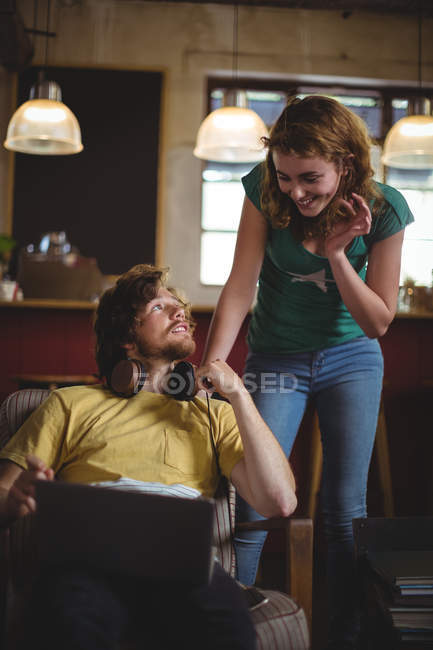 Mechanic interacting while working on laptop in workshop — Stock Photo