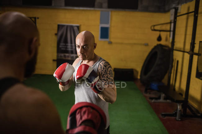 Two thai boxers practicing boxing in gym — Stock Photo