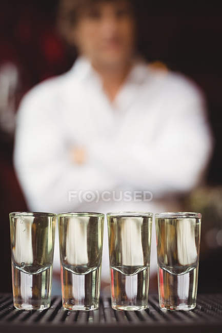 Close-up of tequila in shot glasses on bar counter at bar — Stock Photo