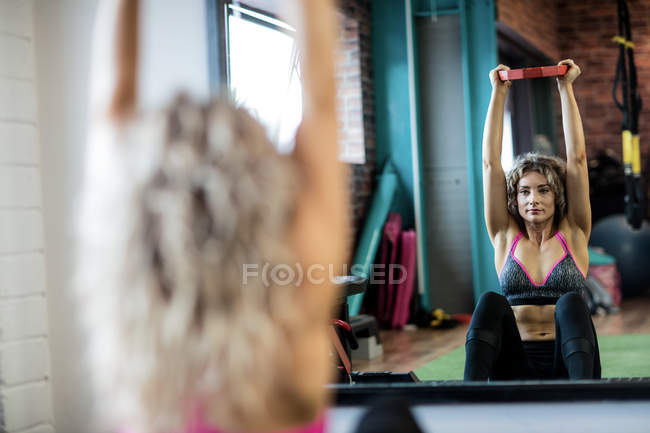 Reflection of beautiful woman working out in gym — Stock Photo