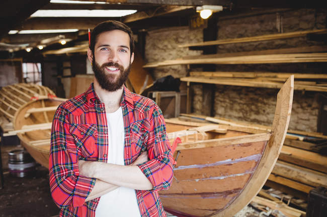Portrait of man standing with arms crossed in boatyard — Stock Photo