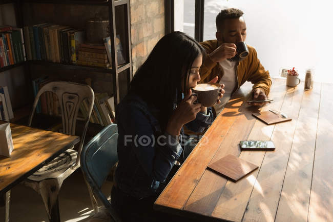 Romantic couple having coffee in cafe — Stock Photo