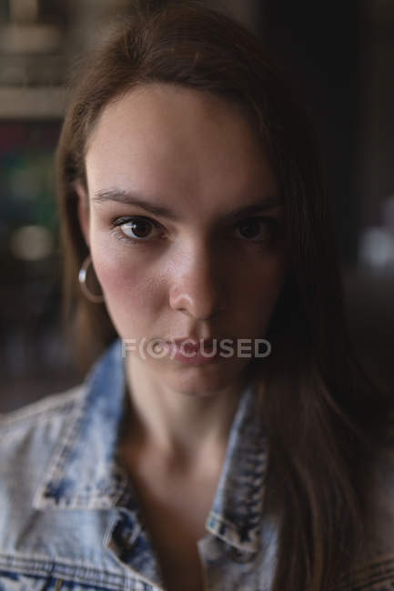 Young female executive looking at camera in office — Stock Photo