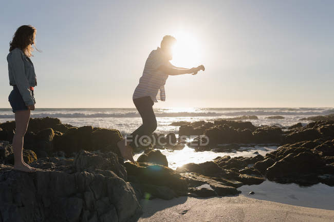 Side view of couple having fun on the beach — Stock Photo