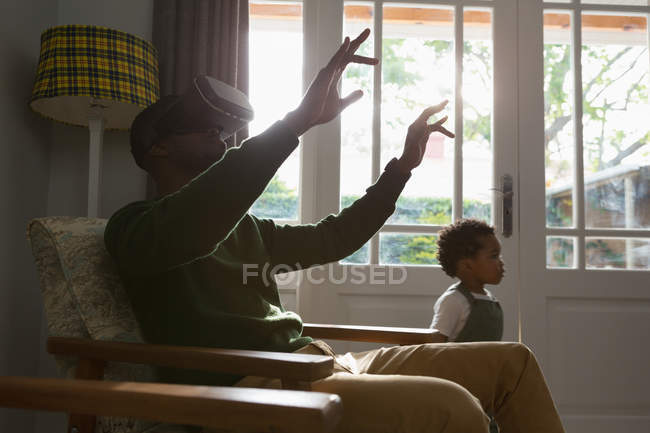 Отец использует очки виртуальной реальности с сыном — стоковое фото