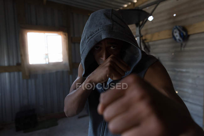 Close-up of male boxer practicing boxing in fitness studio — Stock Photo