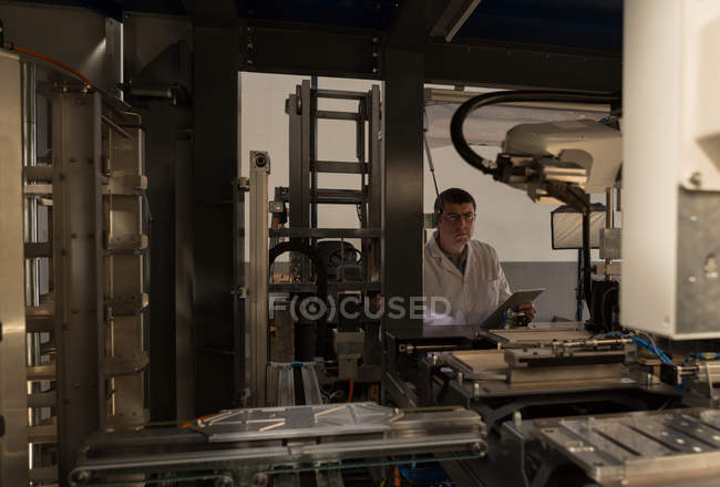 Attentive robotic engineer working in warehouse — Stock Photo