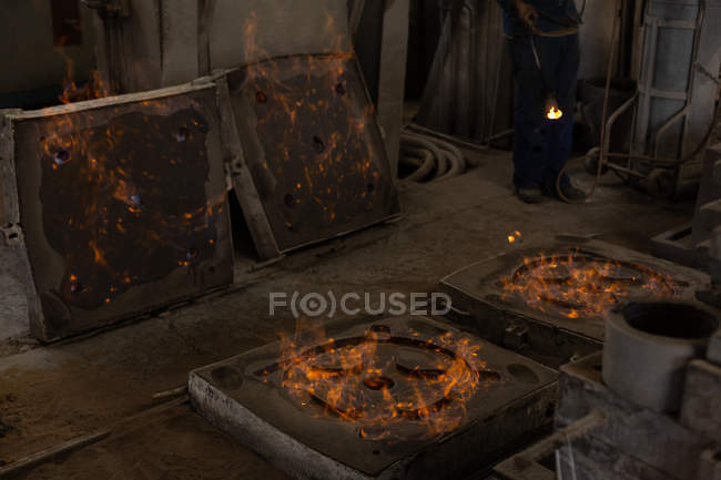 Hot metal castings in molds in foundry — Stock Photo