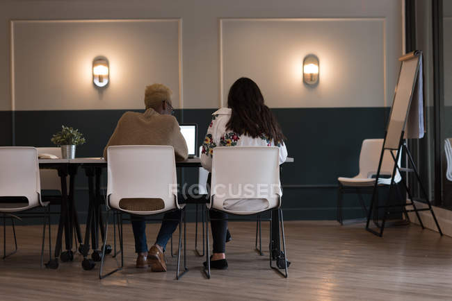 Rear view of business executives working in office — Stock Photo