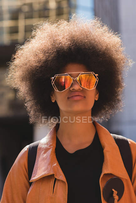 Thoughtful woman in city on a sunny day — Stock Photo